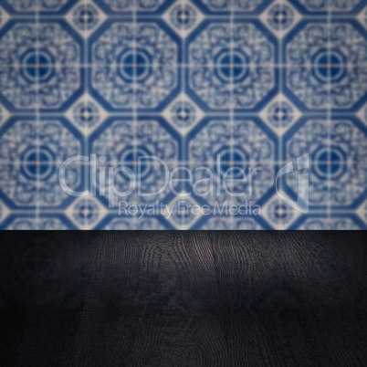 Wood table top and blur vintage ceramic tile pattern wall