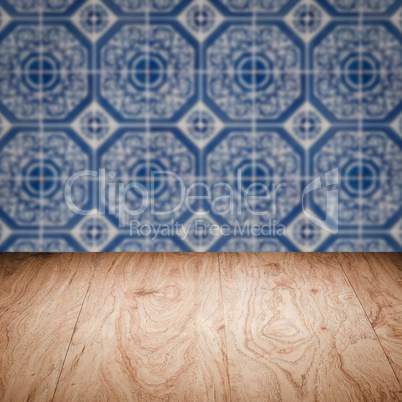 Wood table top and blur vintage ceramic tile pattern wall