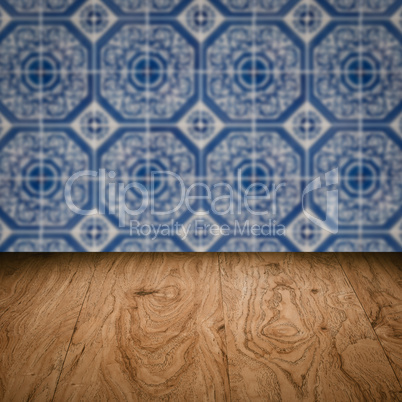 Wood table top and blur vintage ceramic tile pattern wall