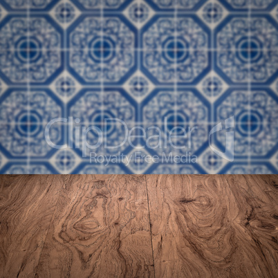 Wood table top and blur vintage ceramic tile pattern wall