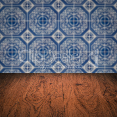 Wood table top and blur vintage ceramic tile pattern wall