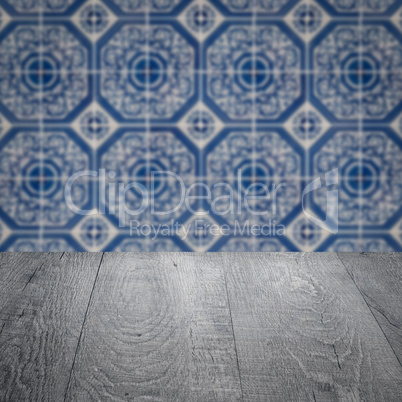 Wood table top and blur vintage ceramic tile pattern wall Wood table top and blur vintage ceramic tile pattern wall