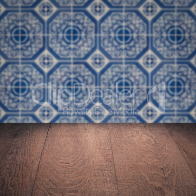 Wood table top and blur vintage ceramic tile pattern wall