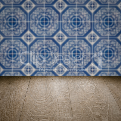 Wood table top and blur vintage ceramic tile pattern wall Wood table top and blur vintage ceramic tile pattern wall