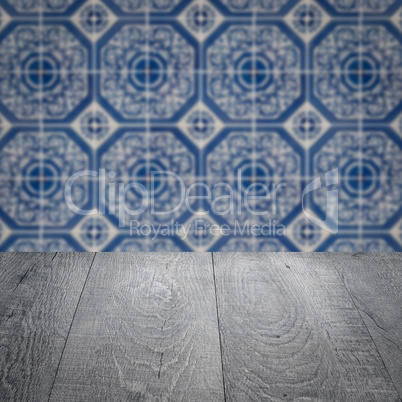 Wood table top and blur vintage ceramic tile pattern wall