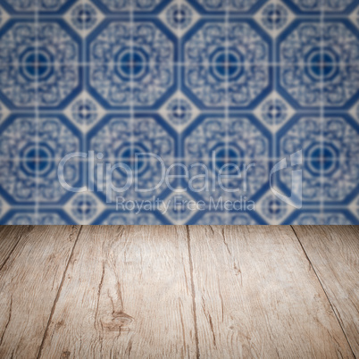 Wood table top and blur vintage ceramic tile pattern wall