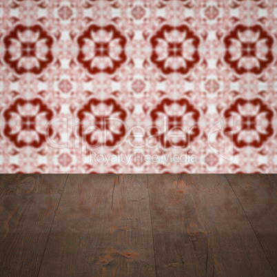 Wood table top and blur vintage ceramic tile pattern wall