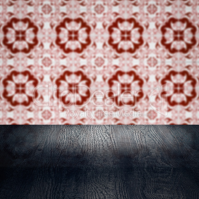 Wood table top and blur vintage ceramic tile pattern wall