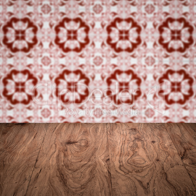 Wood table top and blur vintage ceramic tile pattern wall