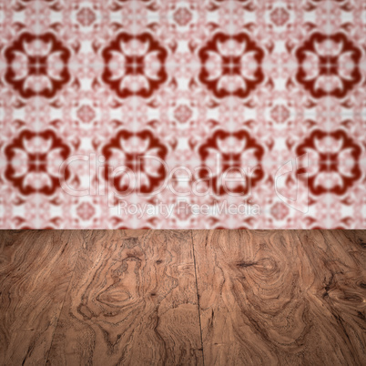 Wood table top and blur vintage ceramic tile pattern wall