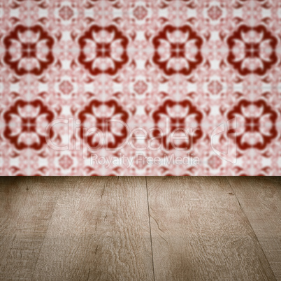 Wood table top and blur vintage ceramic tile pattern wall Wood table top and blur vintage ceramic tile pattern wall