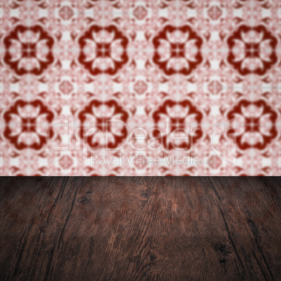 Wood table top and blur vintage ceramic tile pattern wall Wood table top and blur vintage ceramic tile pattern wall
