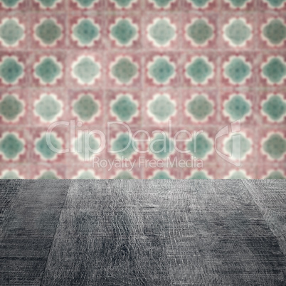 Wood table top and blur vintage ceramic tile pattern wall Wood table top and blur vintage ceramic tile pattern wall