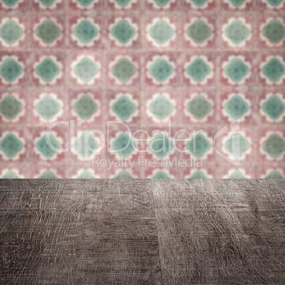 Wood table top and blur vintage ceramic tile pattern wall