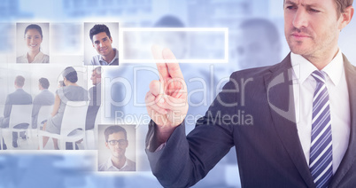 Composite image of businessman pointing with his finger