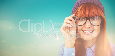 Composite image of smiling hipster woman looking at camera