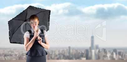 Composite image of pretty redhead businesswoman holding umbrella