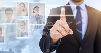 Composite image of businessman pointing his finger at camera