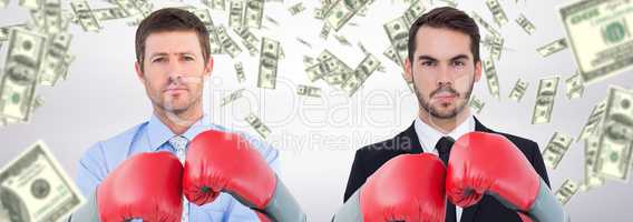 Composite image of businessman with boxing gloves