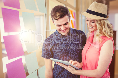 Composite image of happy couple using tablet