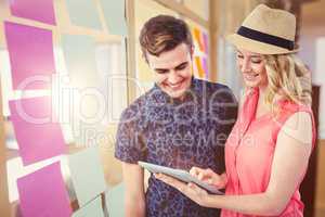 Composite image of happy couple using tablet