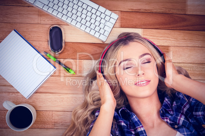 Composite image of a beautiful woman with headphones