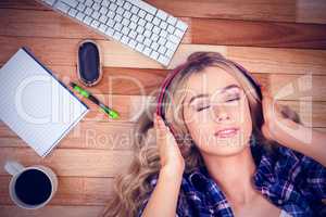 Composite image of a beautiful woman with headphones