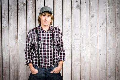 Composite image of serious blond hipster staring at camera