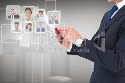 Composite image of businessman in suit using digital tablet Composite image of businessman in suit using digital tablet