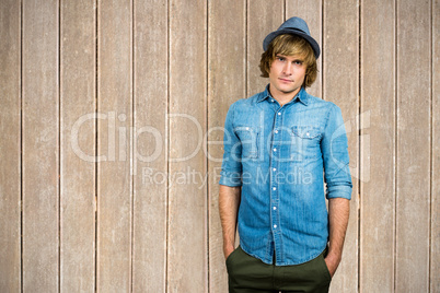 Composite image of serious blond hipster staring at camera