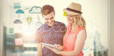 Composite image of happy couple using tablet