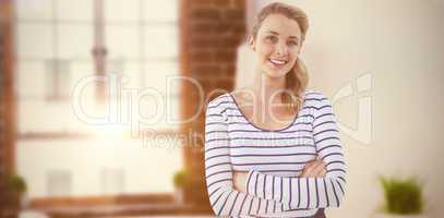Composite image of smiling creative businesswoman by her desk