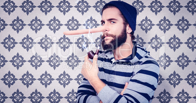 Composite image of portrait of serious hipster smoking pipe