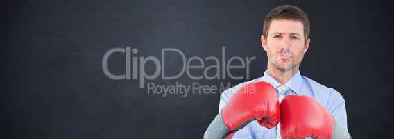 Composite image of businessman with boxing gloves