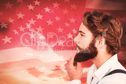 Composite image of profile view of hipster touching beard