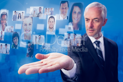 Composite image of concentrated businessman with palm up