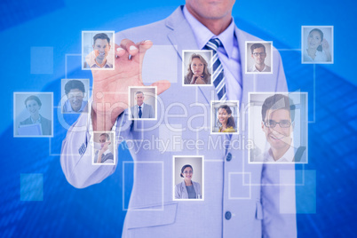 Composite image of businessman touching invisible screen