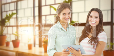Composite image of smiling businesswoman with tablet