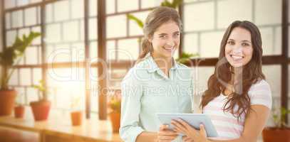 Composite image of smiling businesswoman with tablet