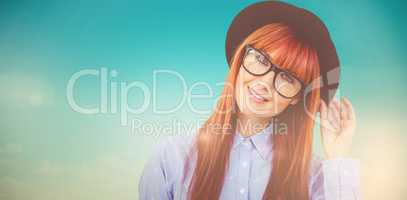 Composite image of smiling hipster woman posing face to the came