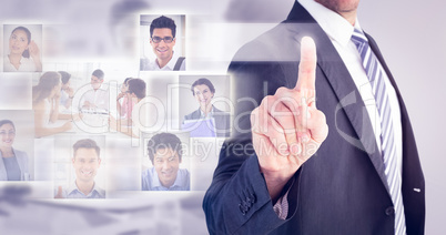 Composite image of businessman pointing with his finger