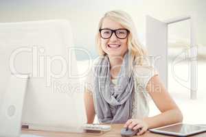 Composite image of portrait of smiling woman using computer