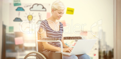 Composite image of woman in wheelchair using computer