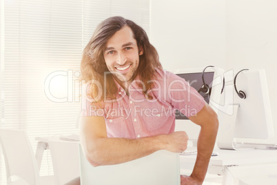 Composite image of portrait of hipster smiling while sitting on