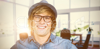 Composite image of smiling blond hipster staring at camera