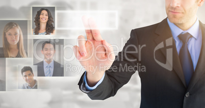 Composite image of businessman pointing these fingers at camera