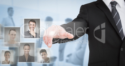 Composite image of businessman in suit pointing his finger