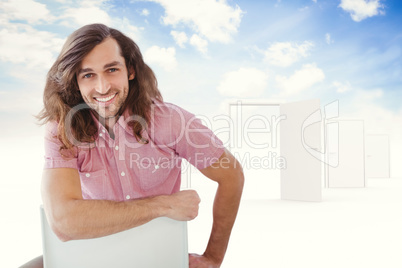 Composite image of portrait of hipster smiling while sitting on