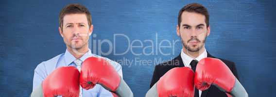 Composite image of businessman with boxing gloves