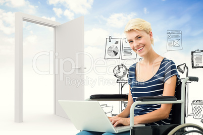 Composite image of woman in wheelchair using computer